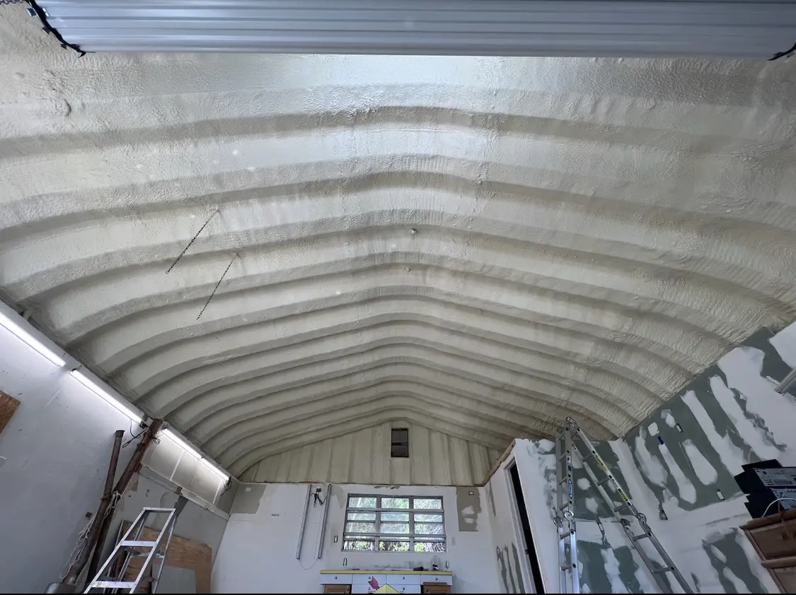 Spray polyurethane foam applied to the underside of a metal roof deck in Jenks